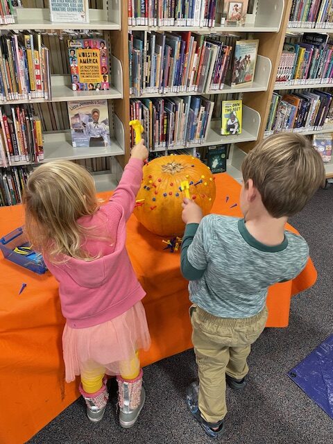 Hammering Golf Tees into Pumpkins